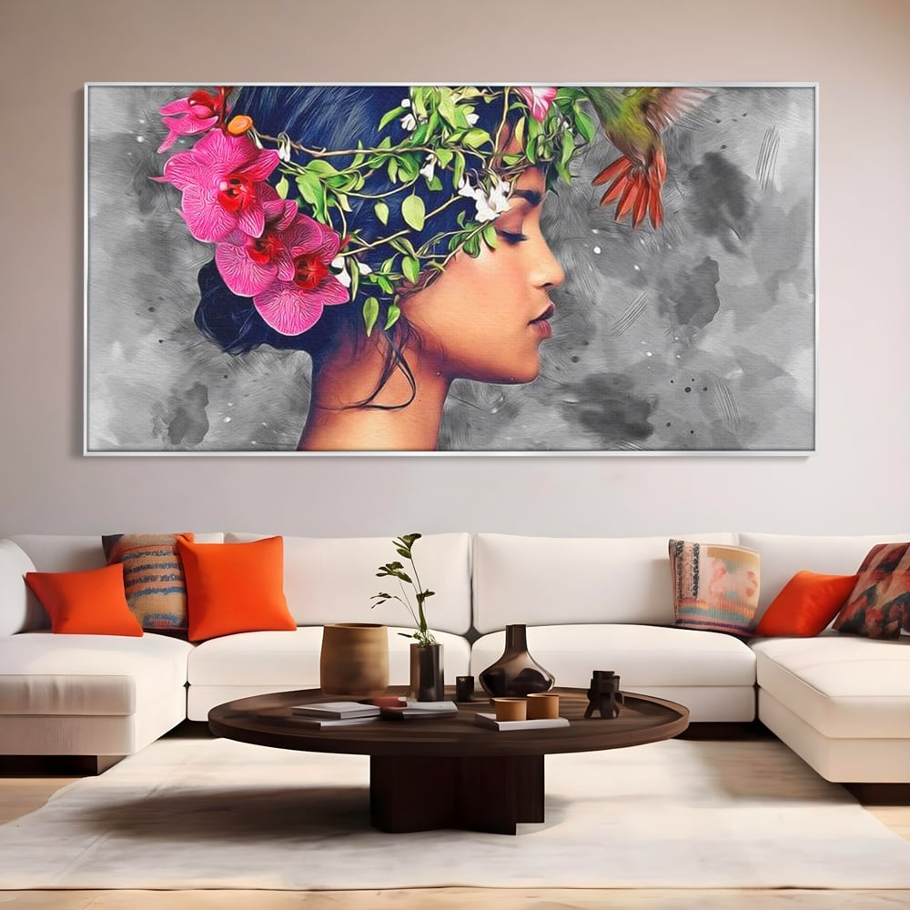 Tablou canvas cu tablou canvas cu portret de femeie si colibri, in rama de aluminiu argintiu, pe perete intr-un living