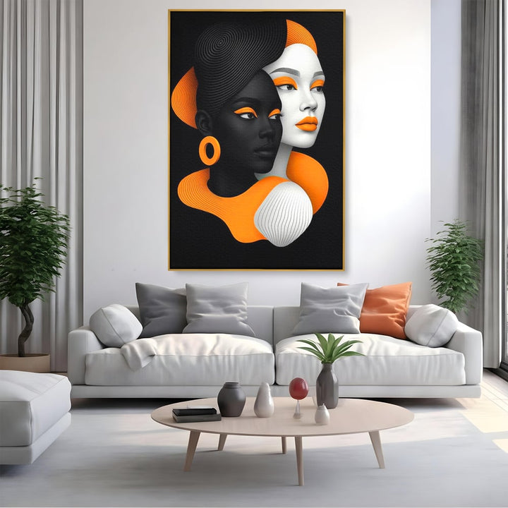Tablou canvas cu ilustratie digitala cu doua chipuri de femeie, in rama de aluminiu auriu, pe perete intr-un living
