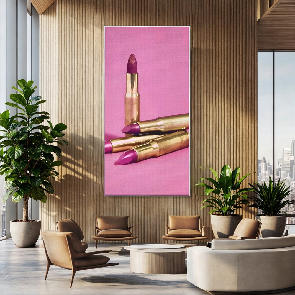 Tablou canvas cu tablou canvas cu rujuri in forme de cartuse pe fond roz, in rama de aluminiu argintiu, pe perete intr-un birou