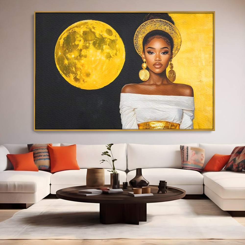 Tablou canvas cu tablou canvas cu femeie si luna aurie, in rama de aluminiu auriu, pe perete intr-un living