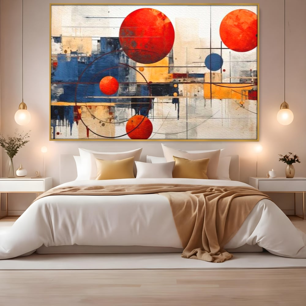 Tablou canvas cu pictura abstracta cu sfere rosii si orbite, in rama de aluminiu auriu, pe perete intr-un dormitor