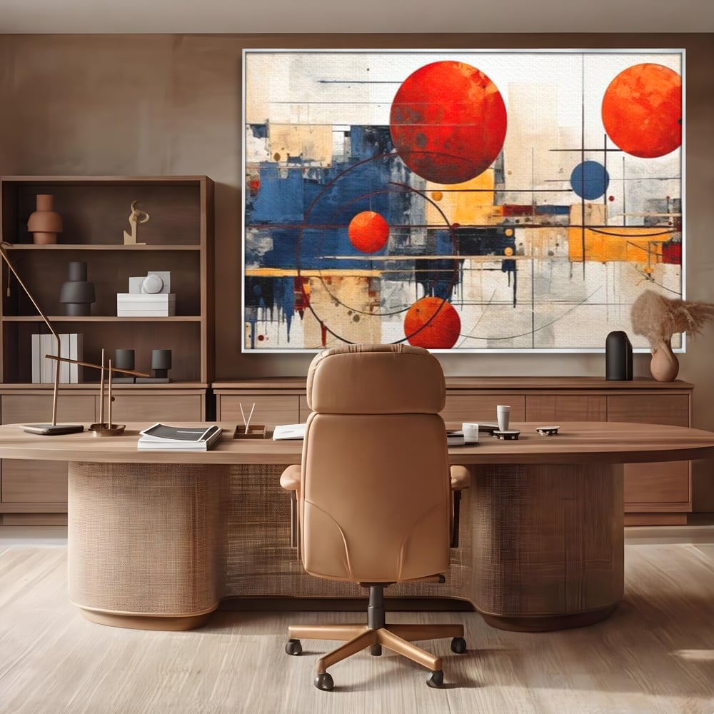 Tablou canvas cu pictura abstracta cu sfere rosii si orbite, in rama de aluminiu argintiu, pe perete intr-un birou