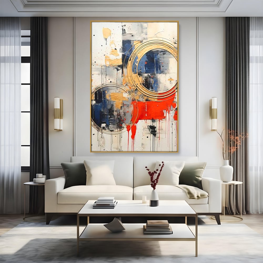 Tablou canvas cu tablou abstract cu cercuri aurii si tuse rosu aprins, in rama de aluminiu auriu, pe perete intr-un living