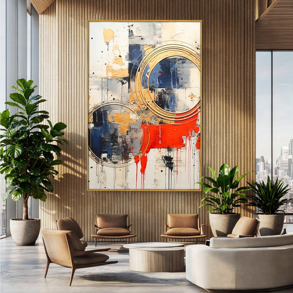 Tablou canvas cu tablou abstract cu cercuri aurii si tuse rosu aprins, in rama de aluminiu auriu, pe perete intr-un birou