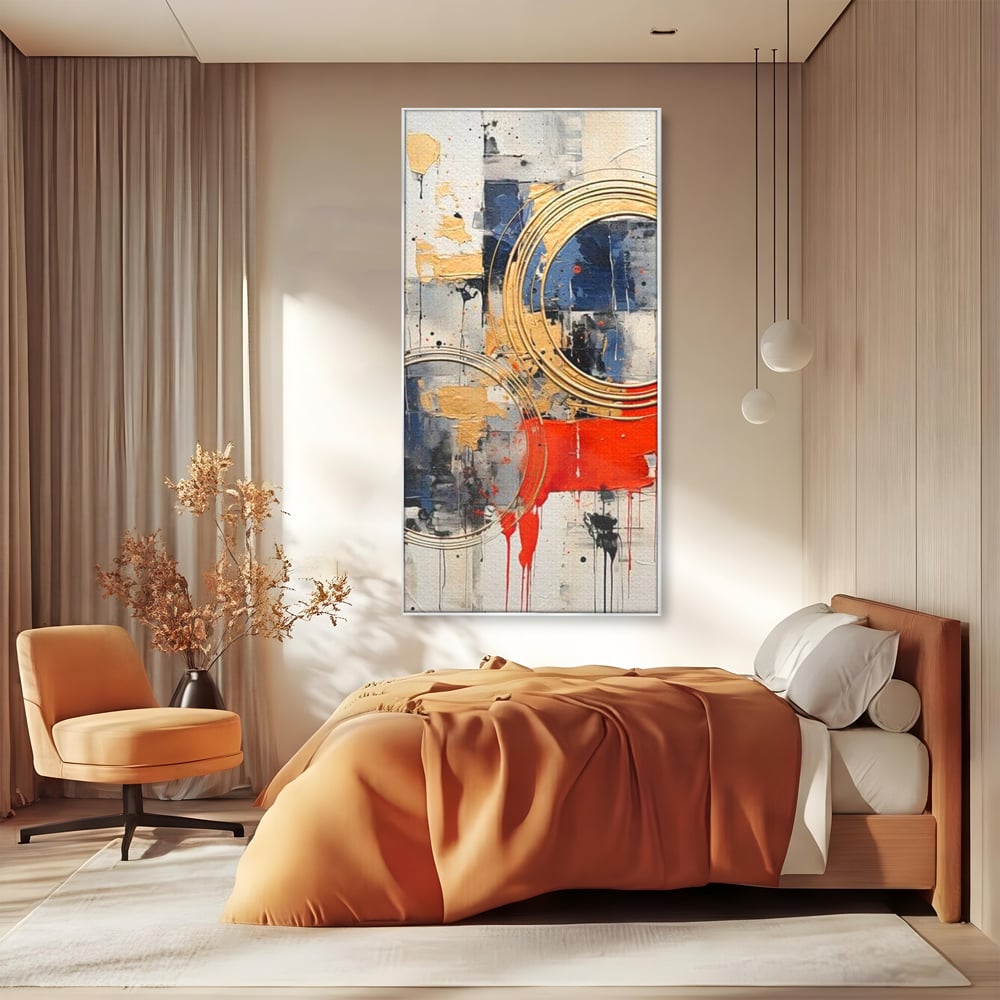 Tablou canvas cu tablou abstract cu cercuri aurii si tuse rosu aprins, in rama de aluminiu argintiu, pe perete intr-un dormitor