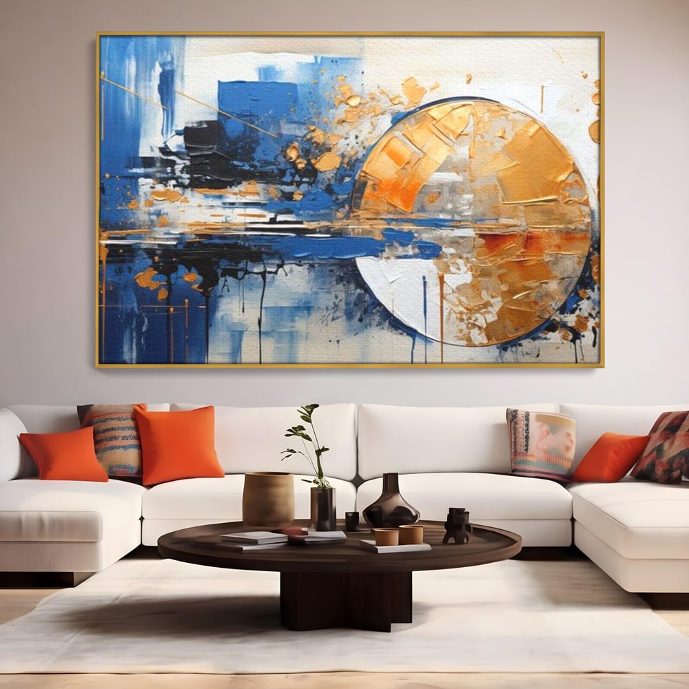 Tablou canvas cu pictura abstracta cu cerc auriu si albastru, in rama de aluminiu auriu, pe perete intr-un living