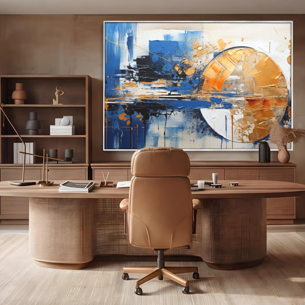 Tablou canvas cu pictura abstracta cu cerc auriu si albastru, in rama de aluminiu argintiu, pe perete intr-un birou