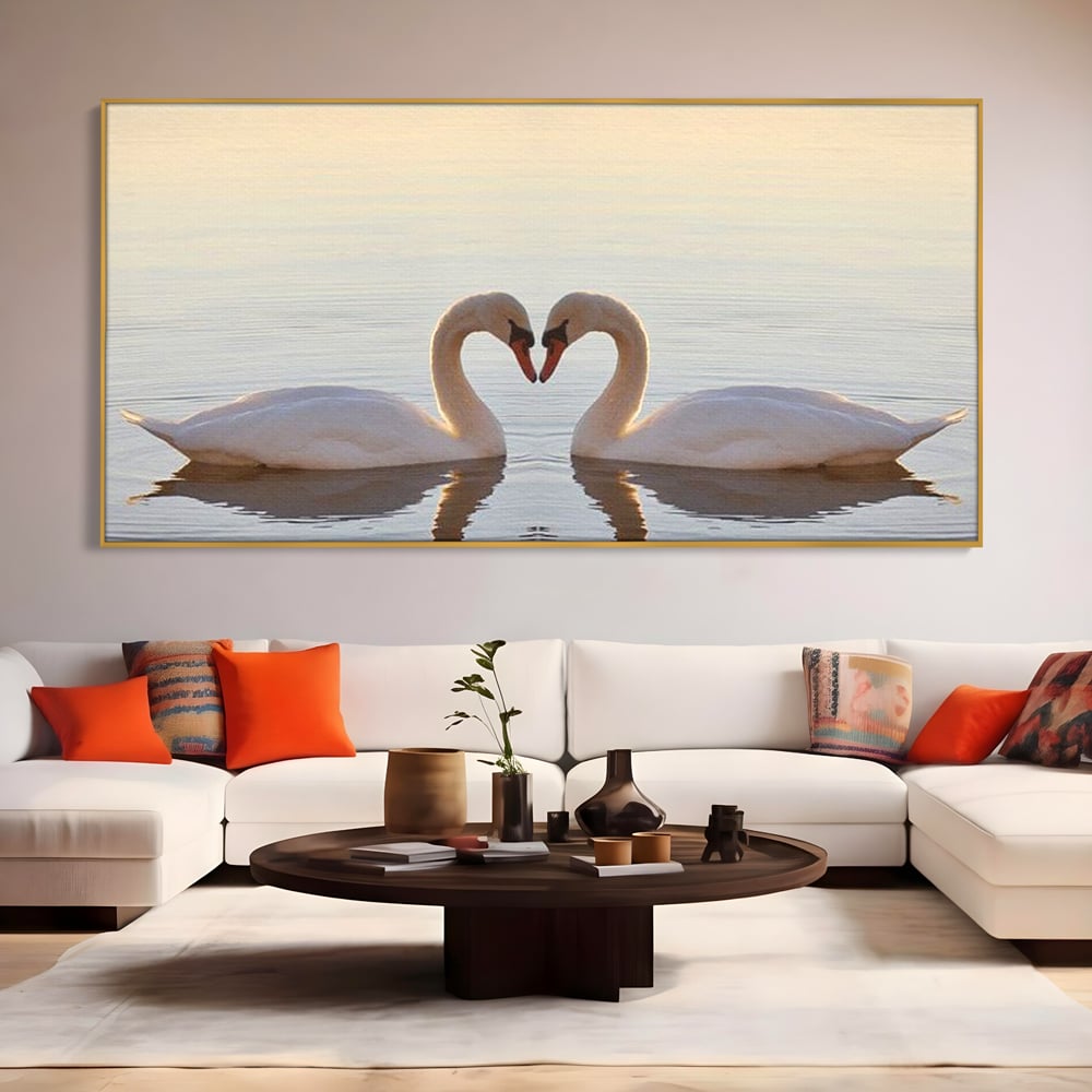 Tablou canvas cu tablou canvas cu lebede pe lac, in rama de aluminiu auriu, pe perete intr-un living