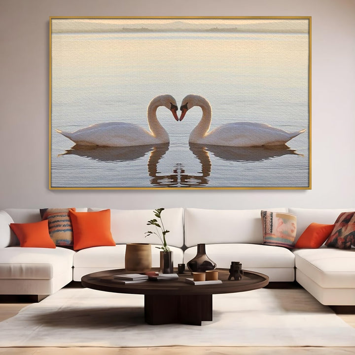 Tablou canvas cu tablou canvas cu lebede pe lac, in rama de aluminiu auriu, pe perete intr-un living