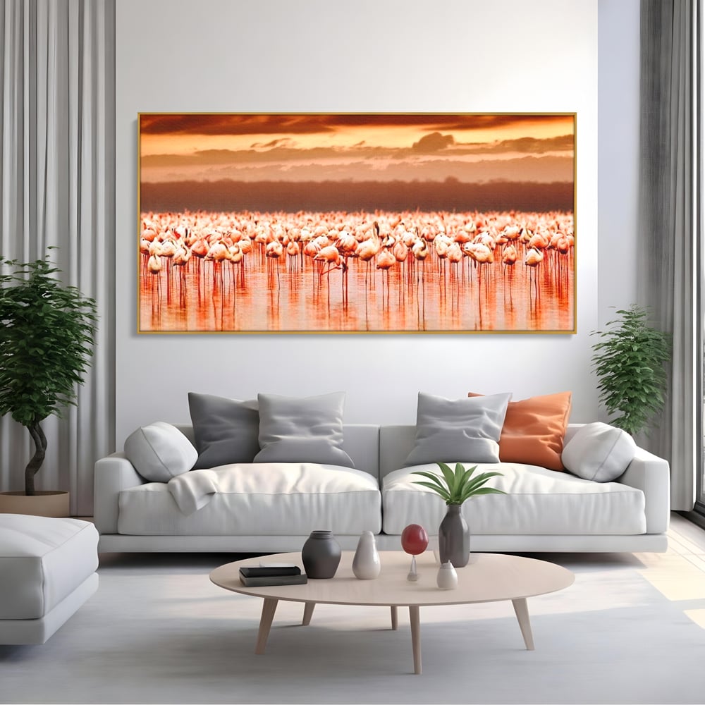 Tablou canvas cu tablou canvas cu stol de flamingo la apus, in rama de aluminiu auriu, pe perete intr-un living
