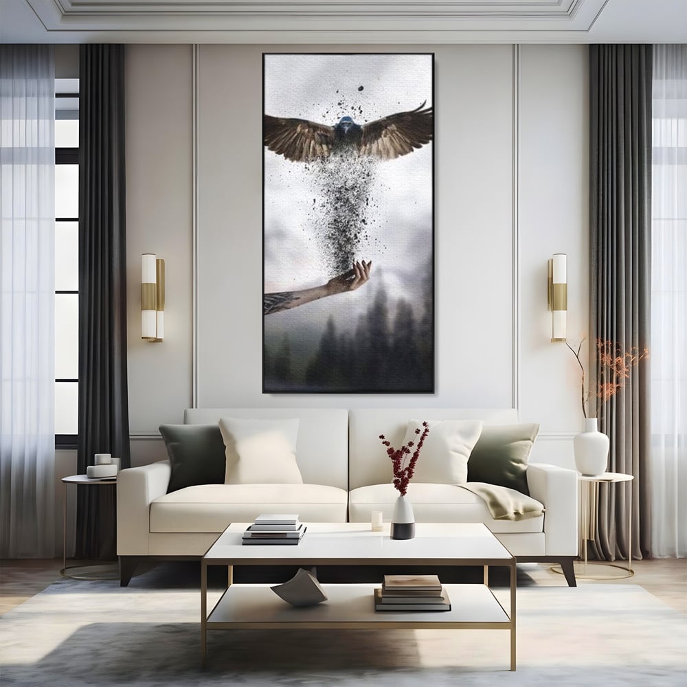 Tablou canvas cu tablou canvas cu pasare si mana din cenusa, in rama de aluminiu negru, pe perete intr-un living