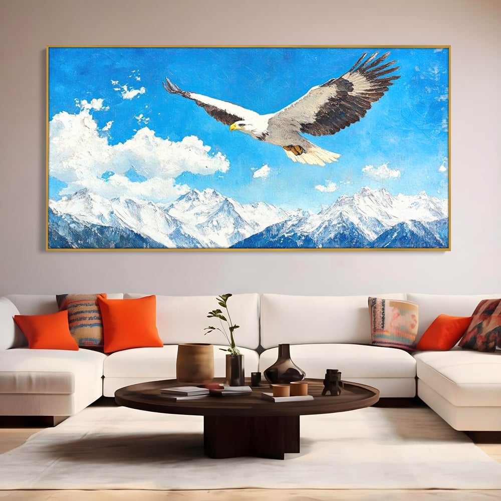 Tablou canvas cu tablou canvas cu vultur in zbor deasupra muntilor, in rama de aluminiu auriu, pe perete intr-un living