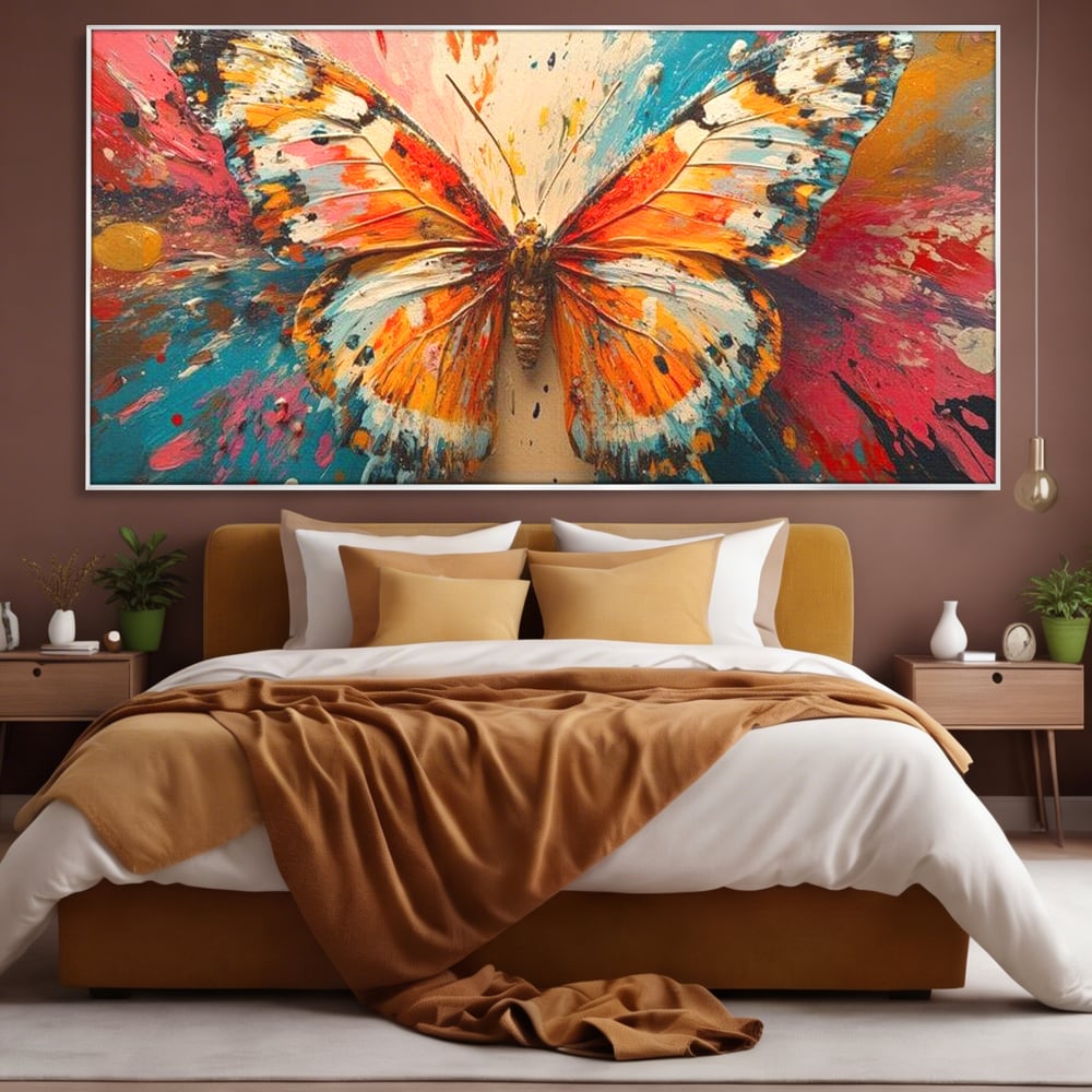 Tablou canvas cu pictura canvas cu fluture portocaliu pe fond cromatic, in rama de aluminiu argintiu, pe perete intr-un dormitor