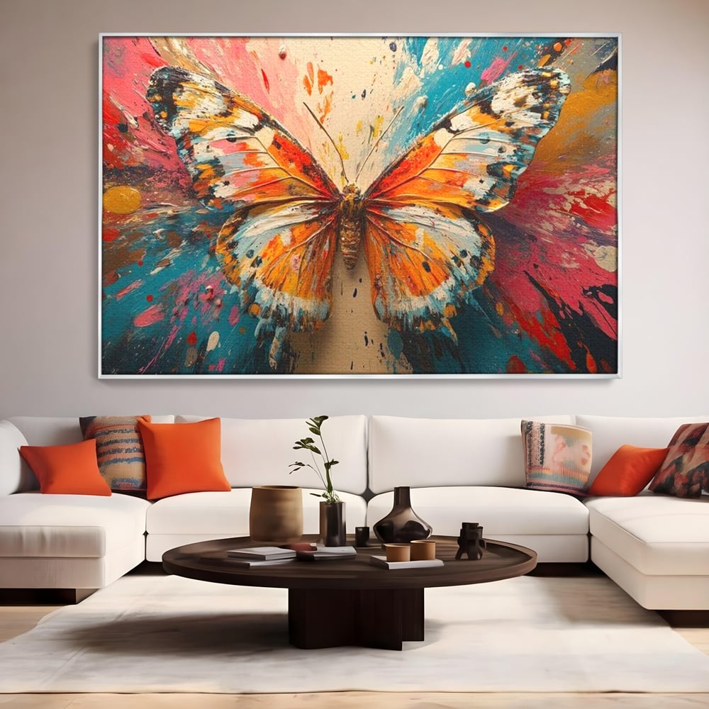 Tablou canvas cu pictura canvas cu fluture portocaliu pe fond cromatic, in rama de aluminiu argintiu, pe perete intr-un living