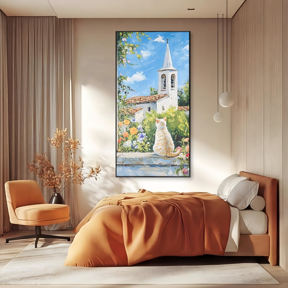 Tablou canvas cu tablou pictura cu pisica alba si biserica, in rama de aluminiu negru, pe perete intr-un dormitor
