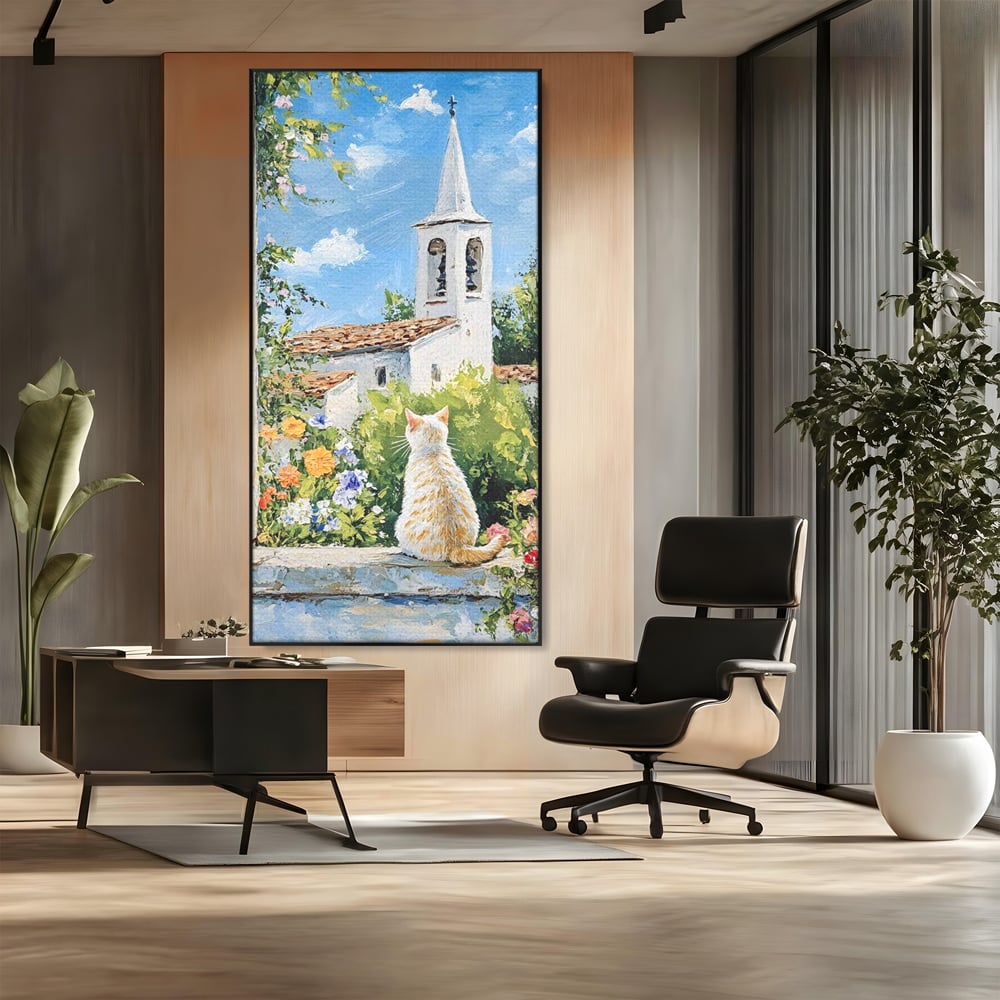 Tablou canvas cu tablou pictura cu pisica alba si biserica, in rama de aluminiu negru, pe perete intr-un birou