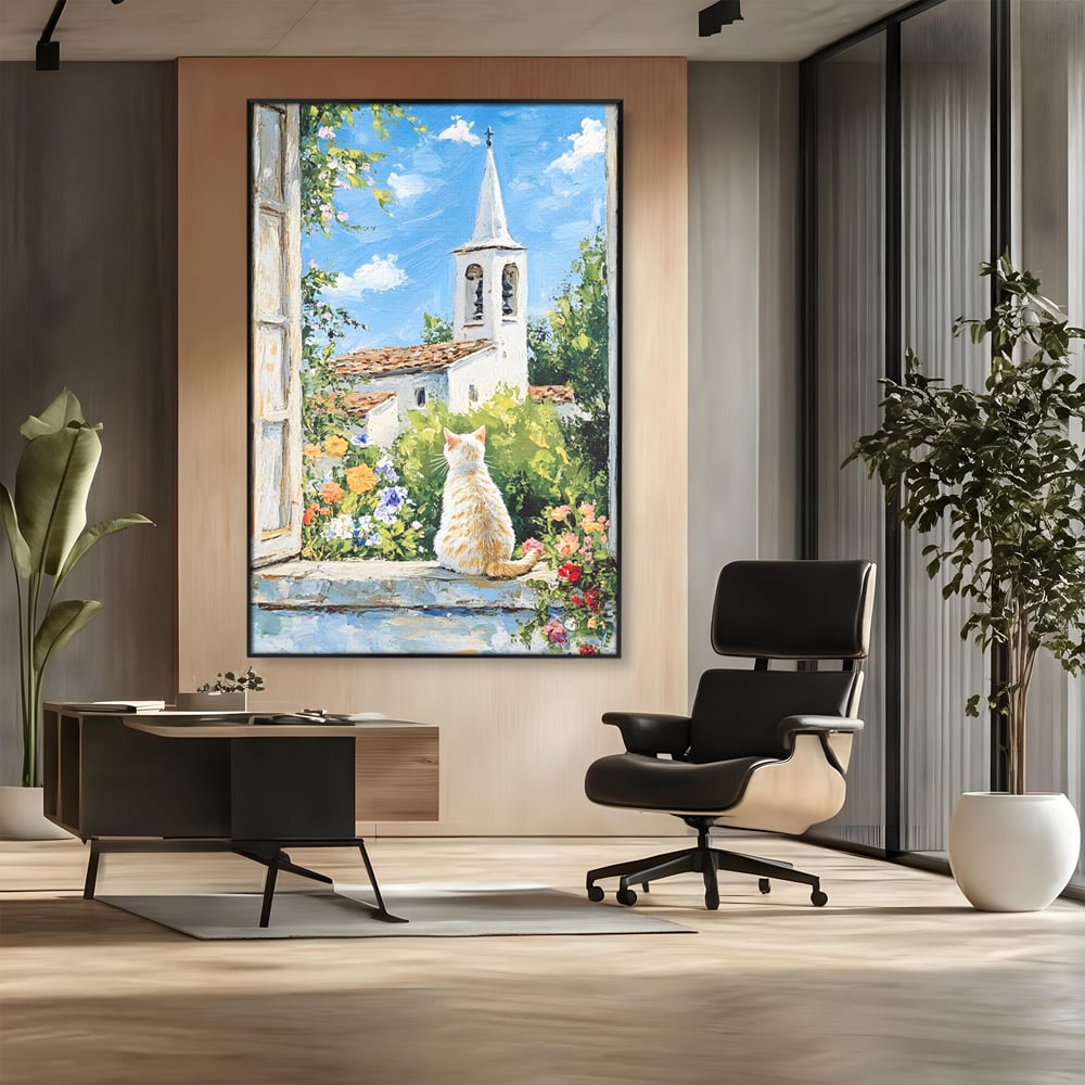 Tablou canvas cu tablou pictura cu pisica alba si biserica, in rama de aluminiu negru, pe perete intr-un birou