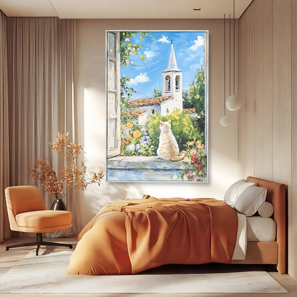 Tablou canvas cu tablou pictura cu pisica alba si biserica, in rama de aluminiu argintiu, pe perete intr-un dormitor