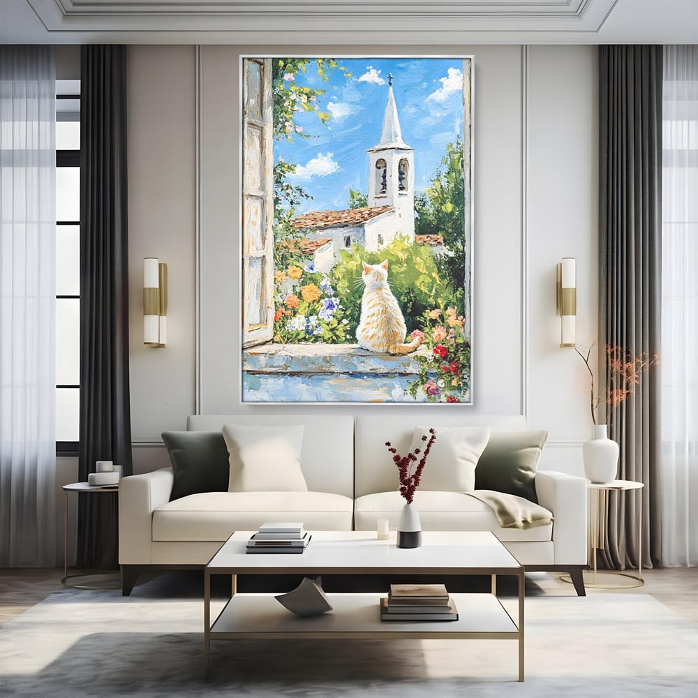 Tablou canvas cu tablou pictura cu pisica alba si biserica, in rama de aluminiu argintiu, pe perete intr-un living