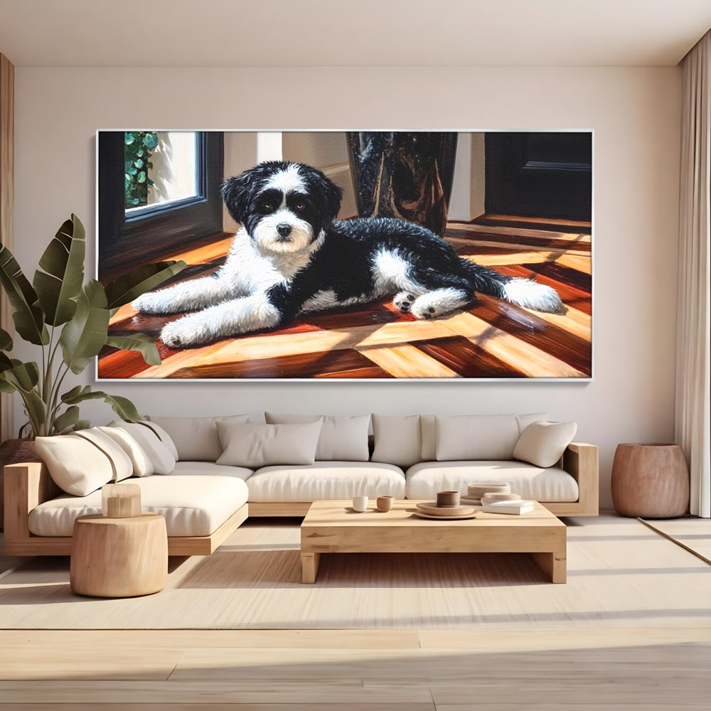 Tablou canvas cu tablou canvas cu catel negru cu alb, in rama de aluminiu argintiu, pe perete intr-un living