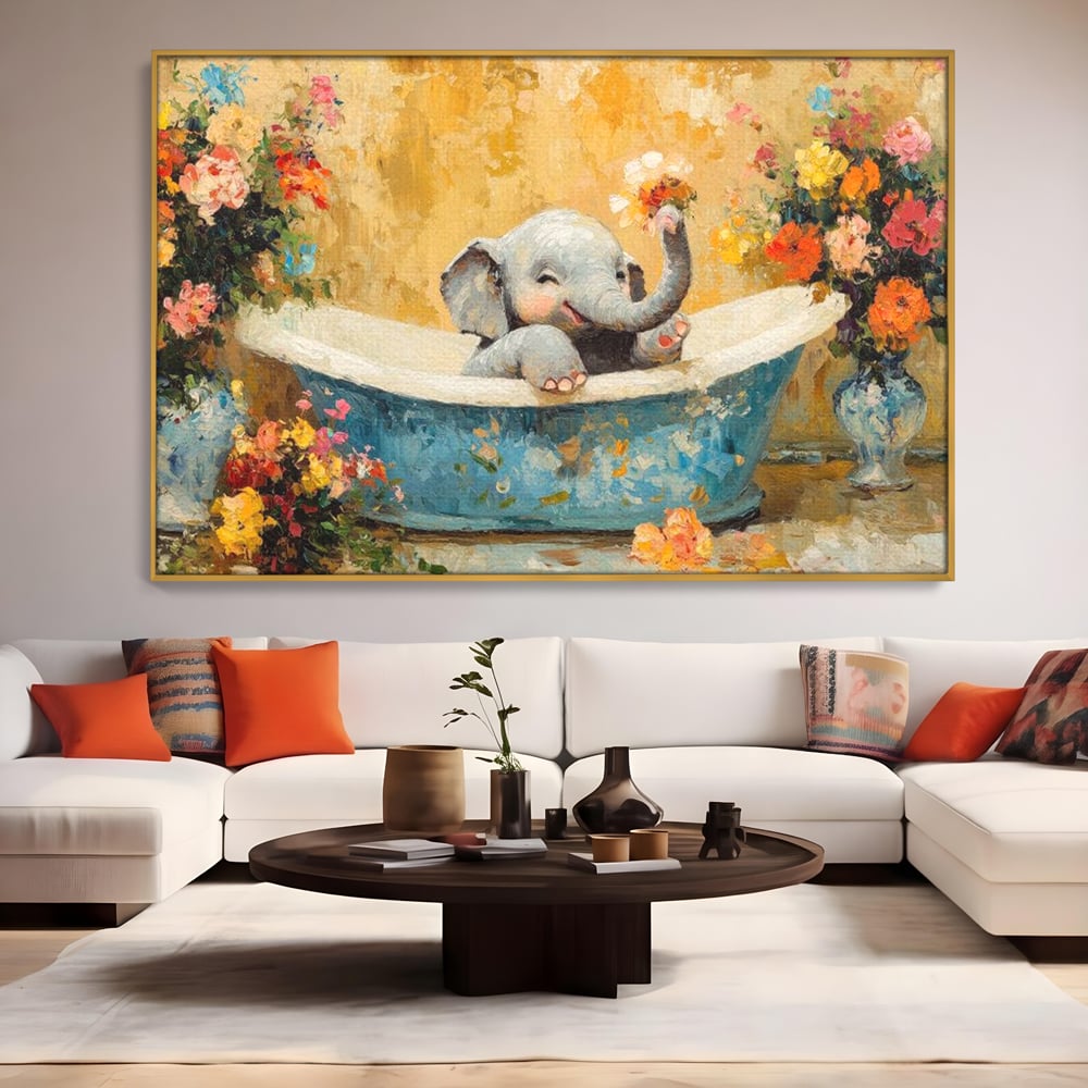 Tablou canvas cu tablou canvas cu pui de elefant in cada, in rama de aluminiu auriu, pe perete intr-un living