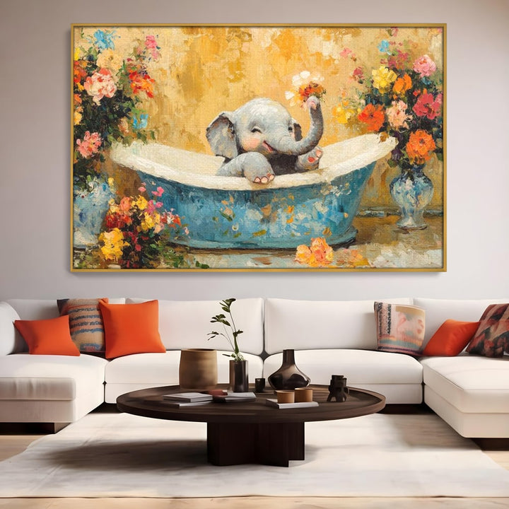 Tablou canvas cu tablou canvas cu pui de elefant in cada, in rama de aluminiu auriu, pe perete intr-un living