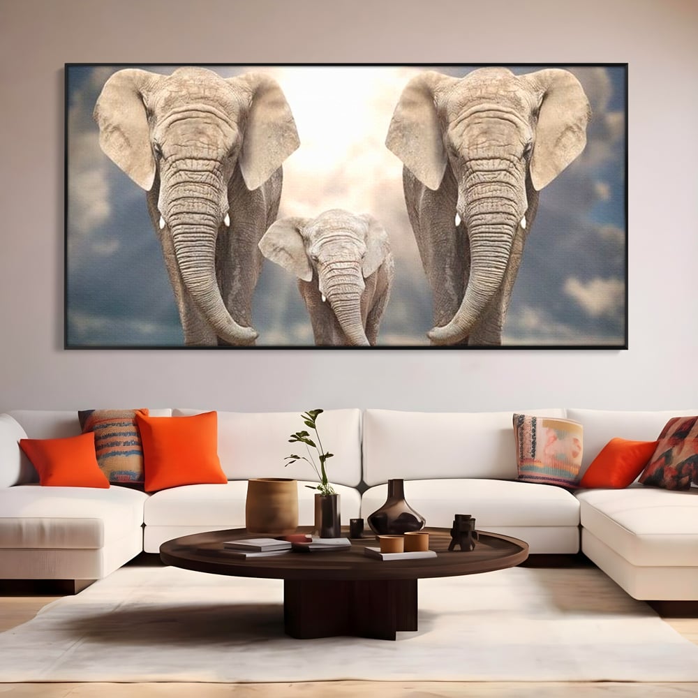 Tablou canvas cu tablou canvas cu trei elefanti, in rama de aluminiu negru, pe perete intr-un living