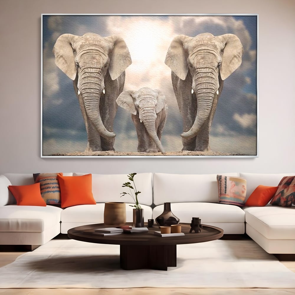 Tablou canvas cu tablou canvas cu trei elefanti, in rama de aluminiu argintiu, pe perete intr-un living