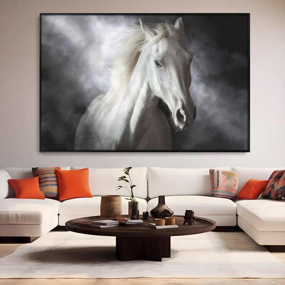 Tablou canvas cu tablou canvas cu un cal alb si nori, in rama de aluminiu negru, pe perete intr-un living