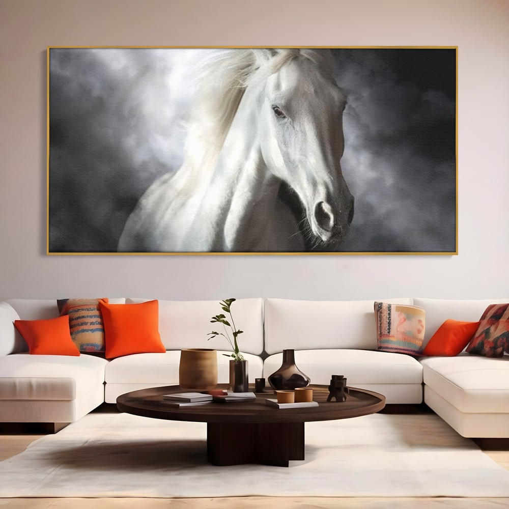 Tablou canvas cu tablou canvas cu un cal alb si nori, in rama de aluminiu auriu, pe perete intr-un living