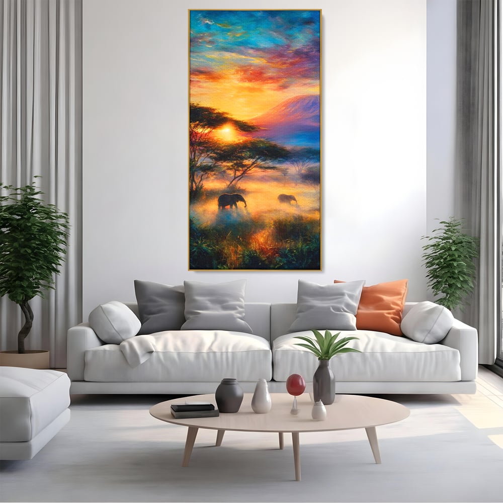 Tablou canvas cu tablou canvas cu elefanti la apus, in rama de aluminiu auriu, pe perete intr-un living