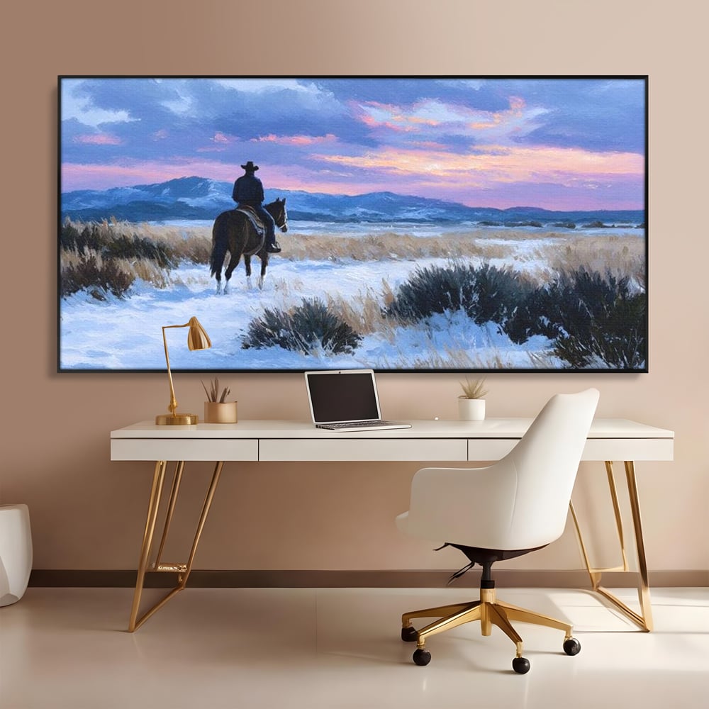 Tablou canvas cu pictura cu calaret cowboy in zapada, in rama de aluminiu negru, pe perete intr-un birou