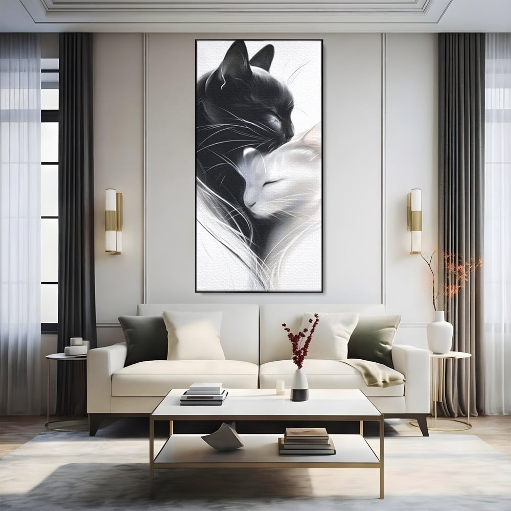 Tablou canvas cu tablou canvas cu pisici alb si negru, in rama de aluminiu negru, pe perete intr-un living
