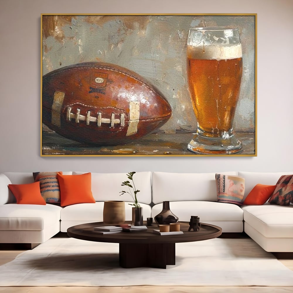 Tablou canvas cu pictura cu minge de fotbal si pahar de bere, in rama de aluminiu auriu, pe perete intr-un living