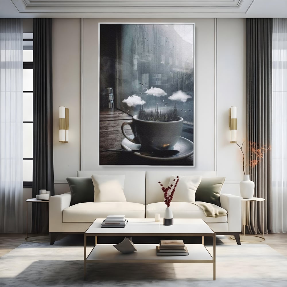Tablou canvas cu ceasca de cafea cu padure si nori, in rama de aluminiu argintiu, pe perete intr-un living