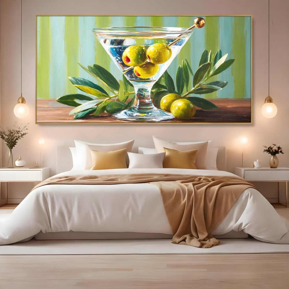 Tablou canvas cu pictura cu pahar martini si masline, in rama de aluminiu auriu, pe perete intr-un dormitor