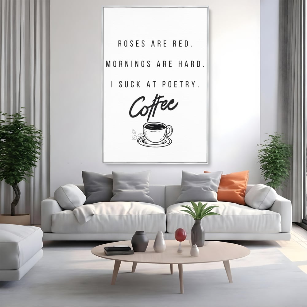 Tablou canvas cu tablou canvas cu text humoristic despre cafea, in rama de aluminiu argintiu, pe perete intr-un living