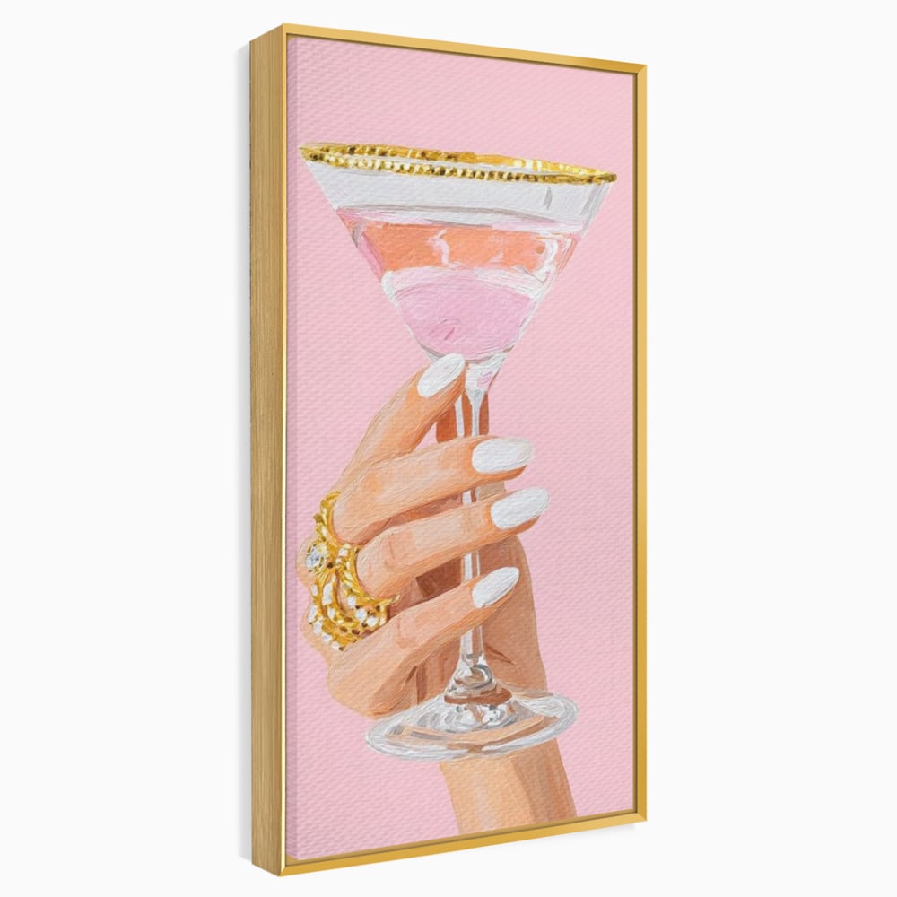 Tablou canvas cu ilustratie cu mana care tine pahar de cocktail, in rama de aluminiu auriu