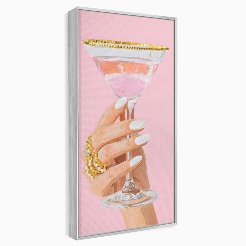 Tablou canvas cu ilustratie cu mana care tine pahar de cocktail, in rama de aluminiu argintiu
