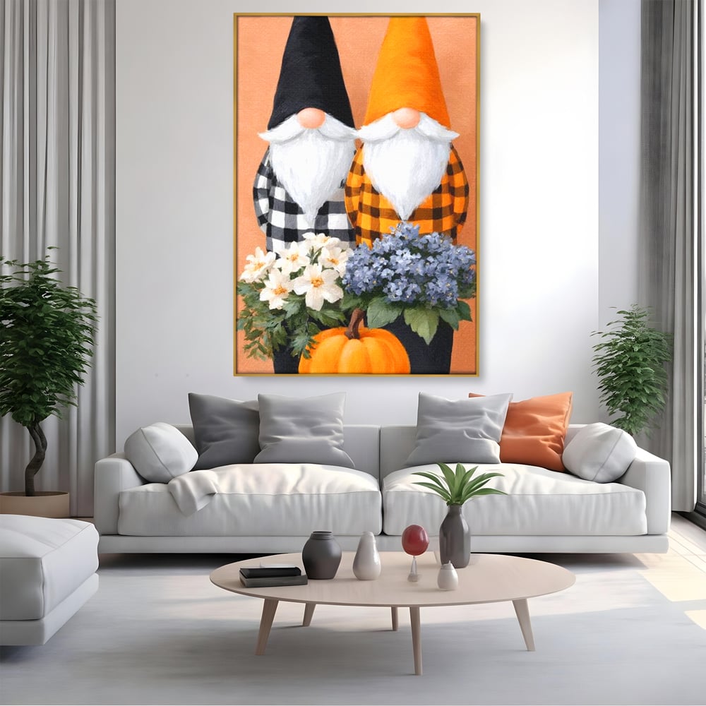 Tablou canvas cu ilustratie cu doi gnomi si dovleac, in rama de aluminiu auriu, pe perete intr-un living