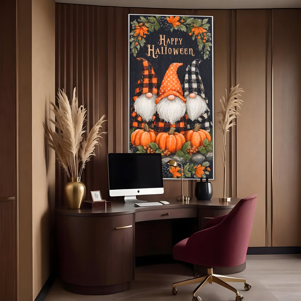 Tablou canvas cu ilustratie cu trei gnomi de halloween, in rama de aluminiu argintiu, pe perete intr-un birou