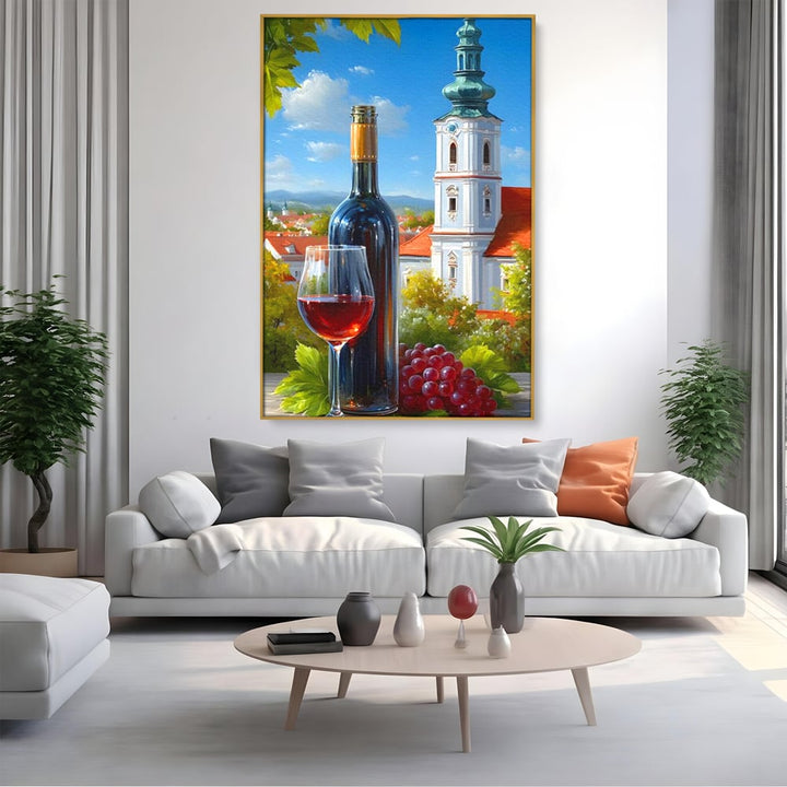 Tablou canvas cu pictura cu sticla de vin si manastire, in rama de aluminiu auriu, pe perete intr-un living
