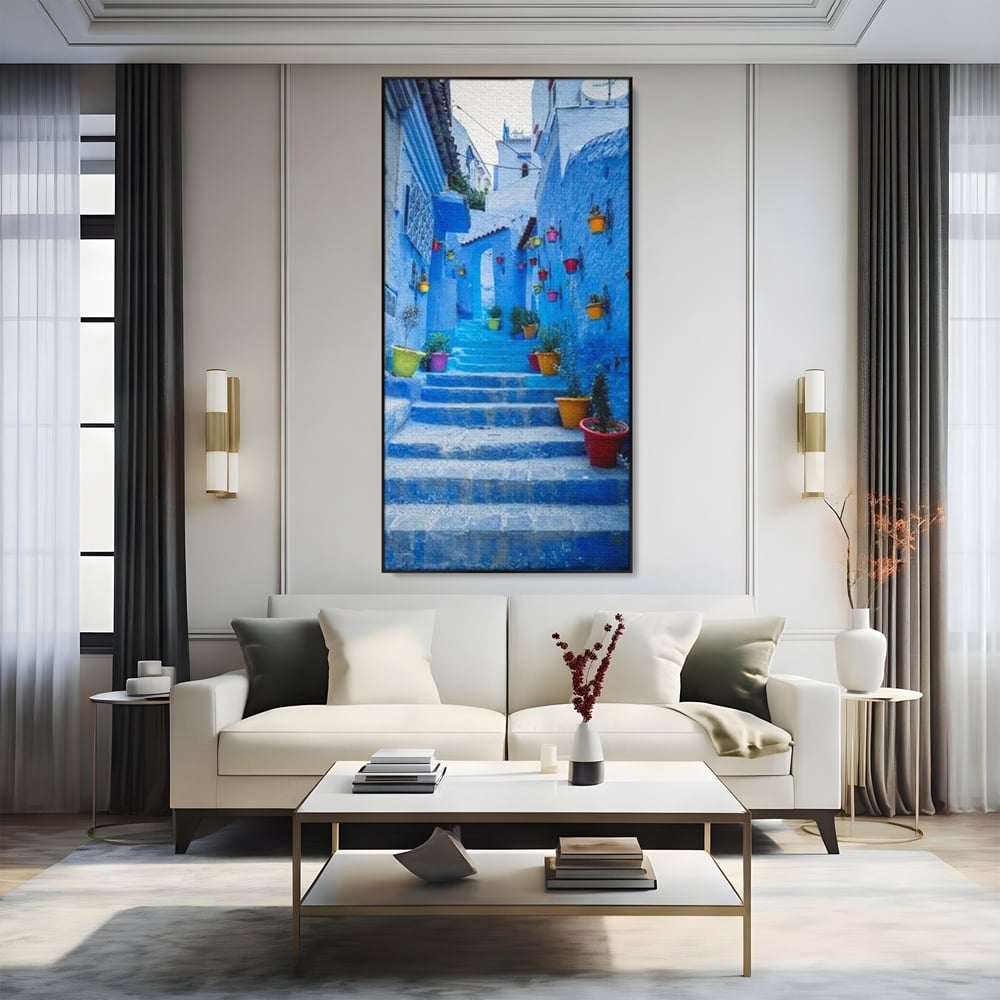 Tablou canvas cu tablou canvas cu straduta albastra din maroc, in rama de aluminiu negru, pe perete intr-un living