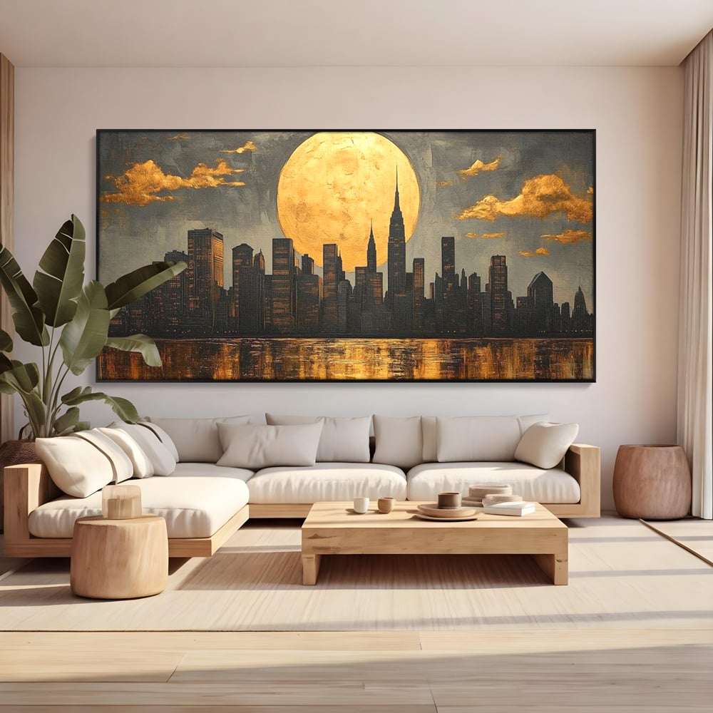 Tablou canvas cu pictura orizontala cu metropola si luna aurie, in rama de aluminiu negru, pe perete intr-un living