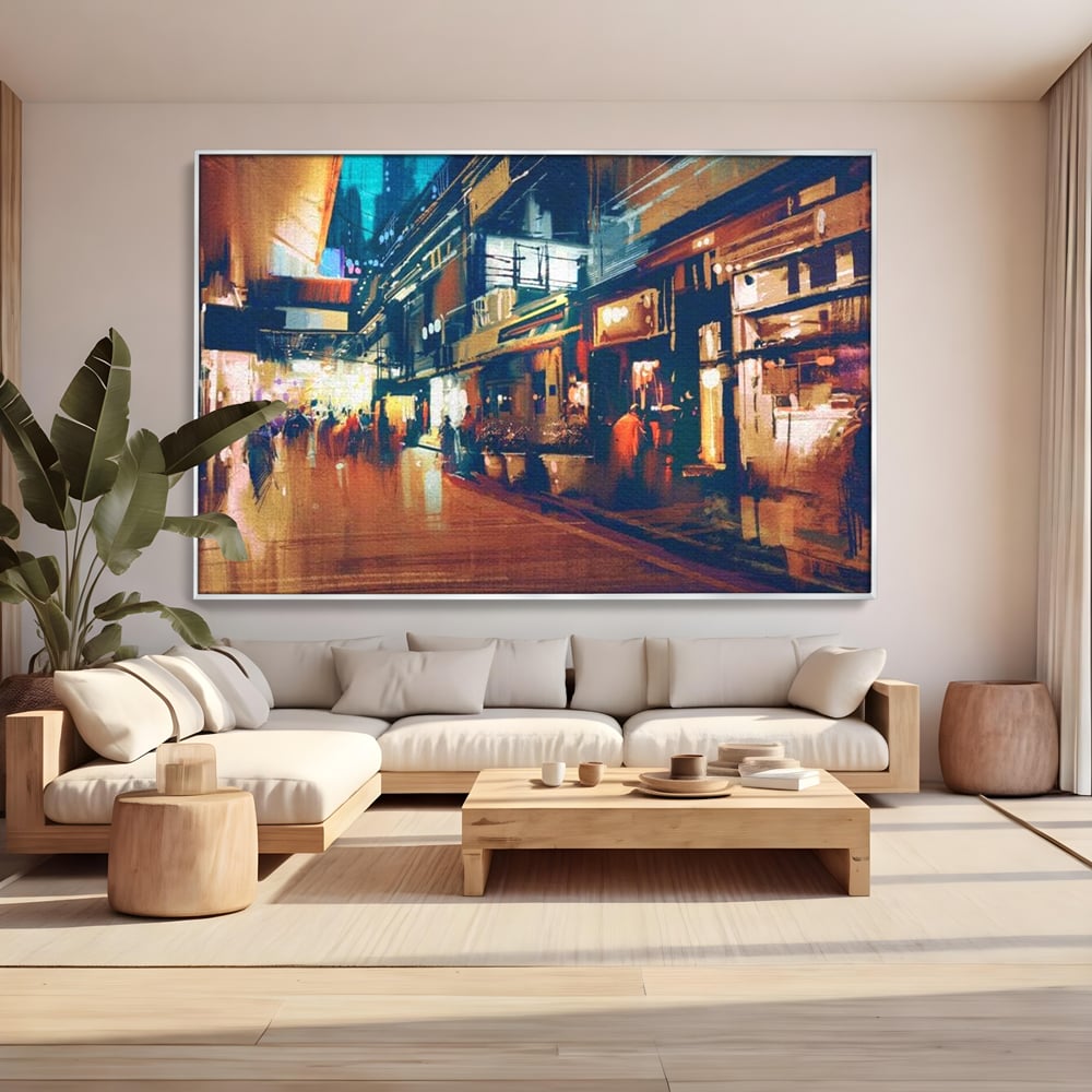 Tablou canvas cu pictura urbana cu strada luminata noaptea, in rama de aluminiu argintiu, pe perete intr-un living