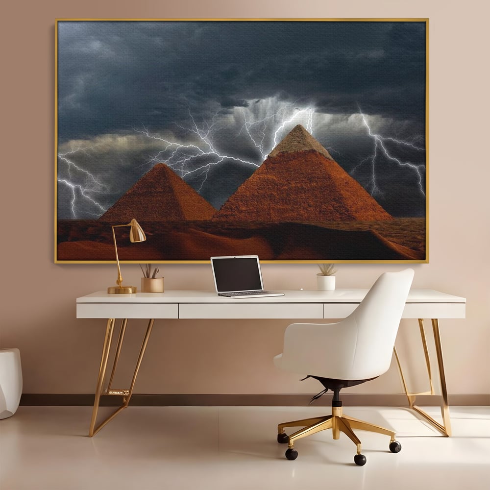 Tablou canvas cu ilustratie cu piramide si fulgere, in rama de aluminiu auriu, pe perete intr-un birou