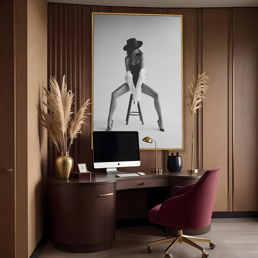 Tablou canvas cu tablou canvas cu femeie pe scaun, in rama de aluminiu auriu, pe perete intr-un birou