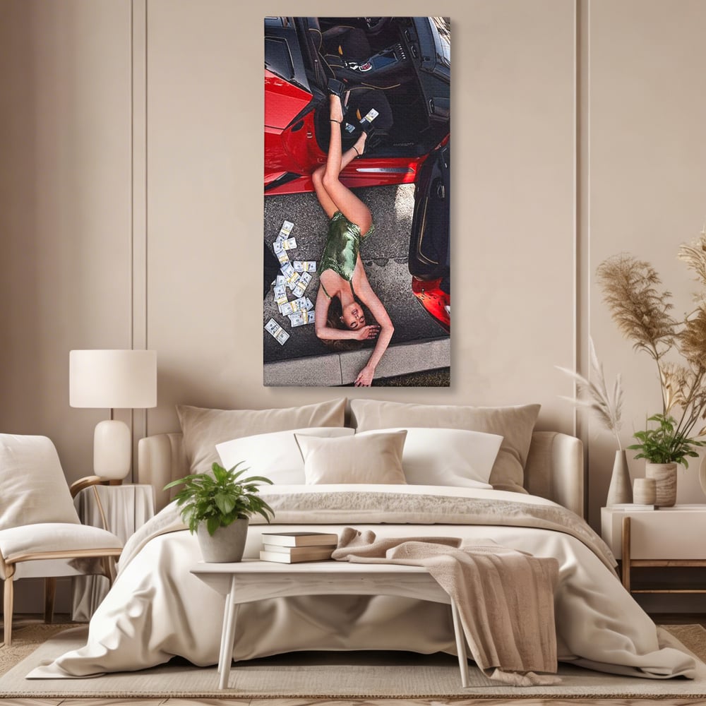 Tablou canvas cu femeie intinsa langa masina rosie si bancnote, fara rama, pe sasiu de lemn, pe perete intr-un dormitor