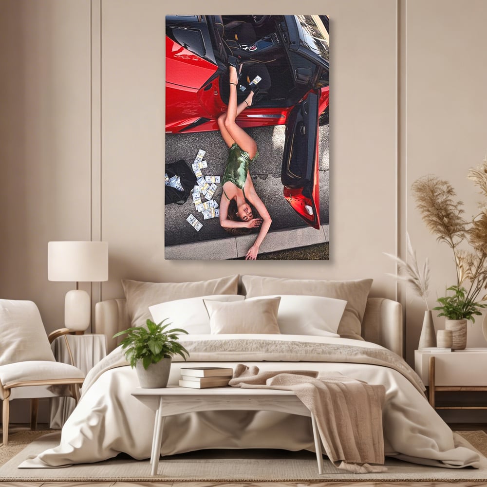Tablou canvas cu femeie intinsa langa masina rosie si bancnote, fara rama, pe sasiu de lemn, pe perete intr-un dormitor
