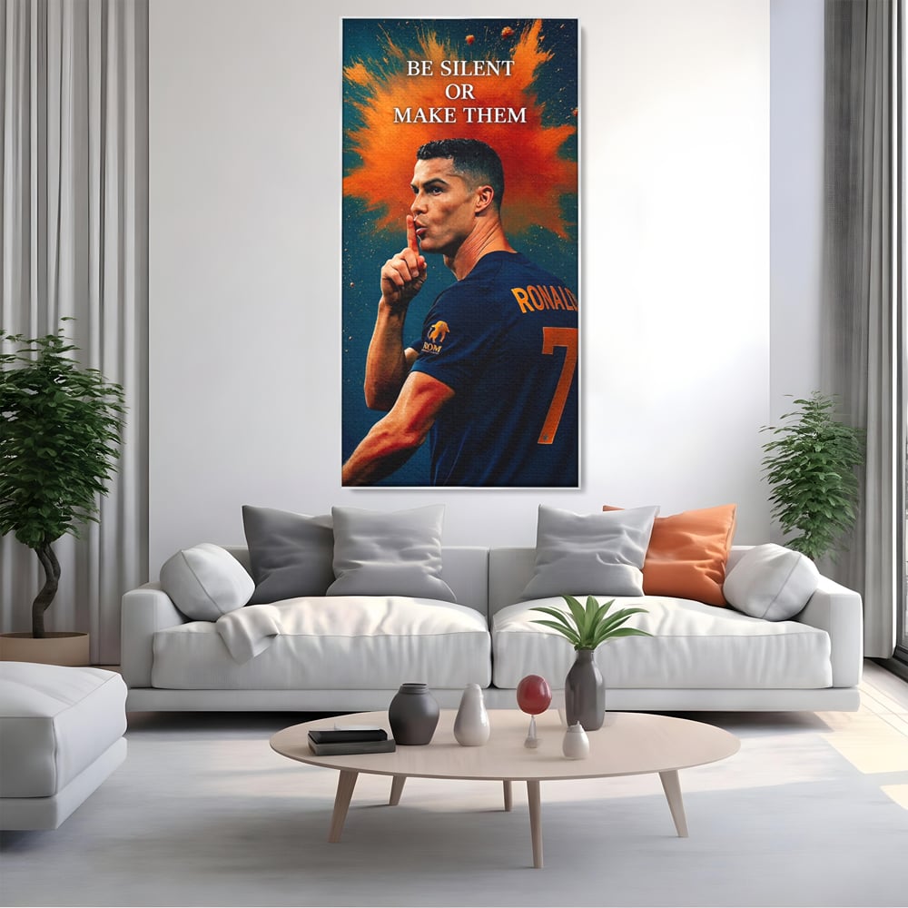 Tablou canvas cu tablou motivational cu portretul lui ronaldo, in rama de aluminiu argintiu, pe perete intr-un living